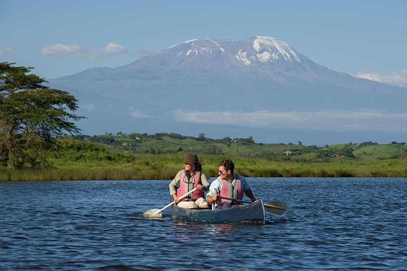 Canoeists on Lake Momella, Kilimanjaro in the background